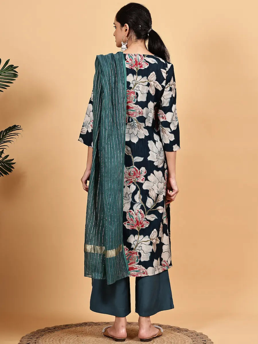 Woman wearing a floral kurta with a green dupatta on a beige background