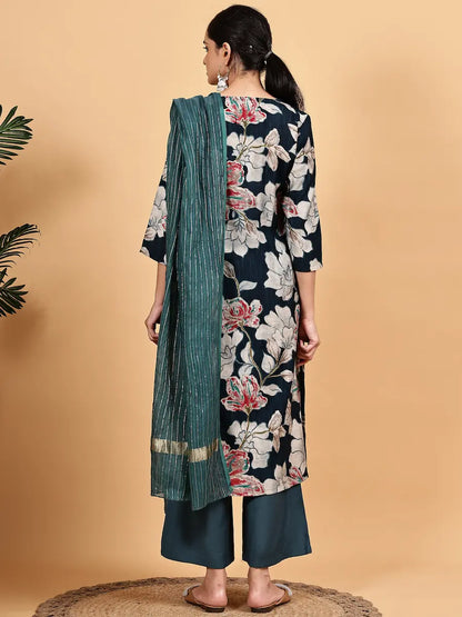 Woman wearing a floral kurta with a green dupatta on a beige background