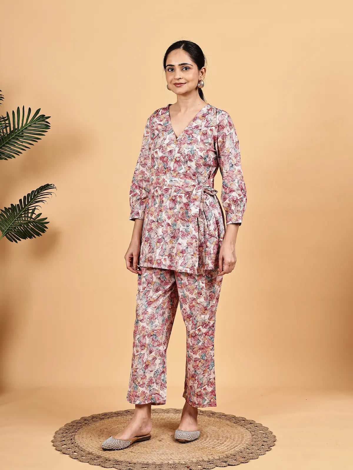 Woman wearing a floral outfit on a beige background
