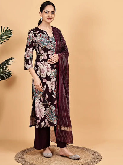 Woman wearing a floral kurta with a matching dupatta on a beige background