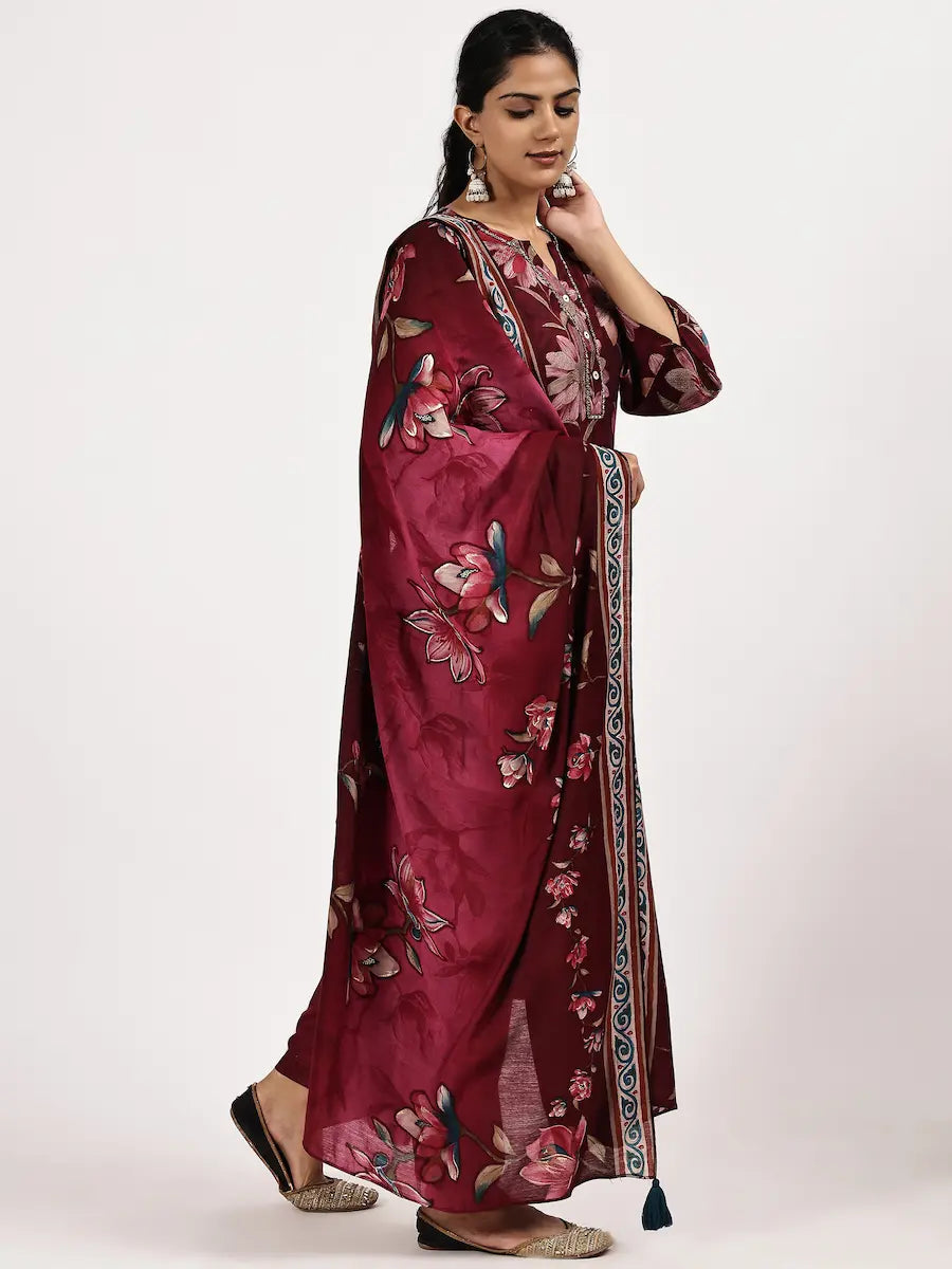 Woman wearing a maroon floral dress on a white background
