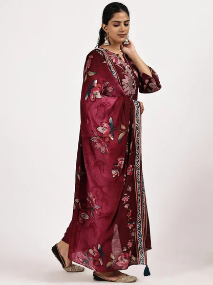 Woman wearing a maroon floral dress on a white background