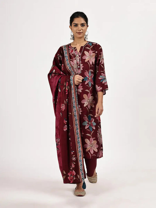 Woman wearing a maroon floral dress on a white background